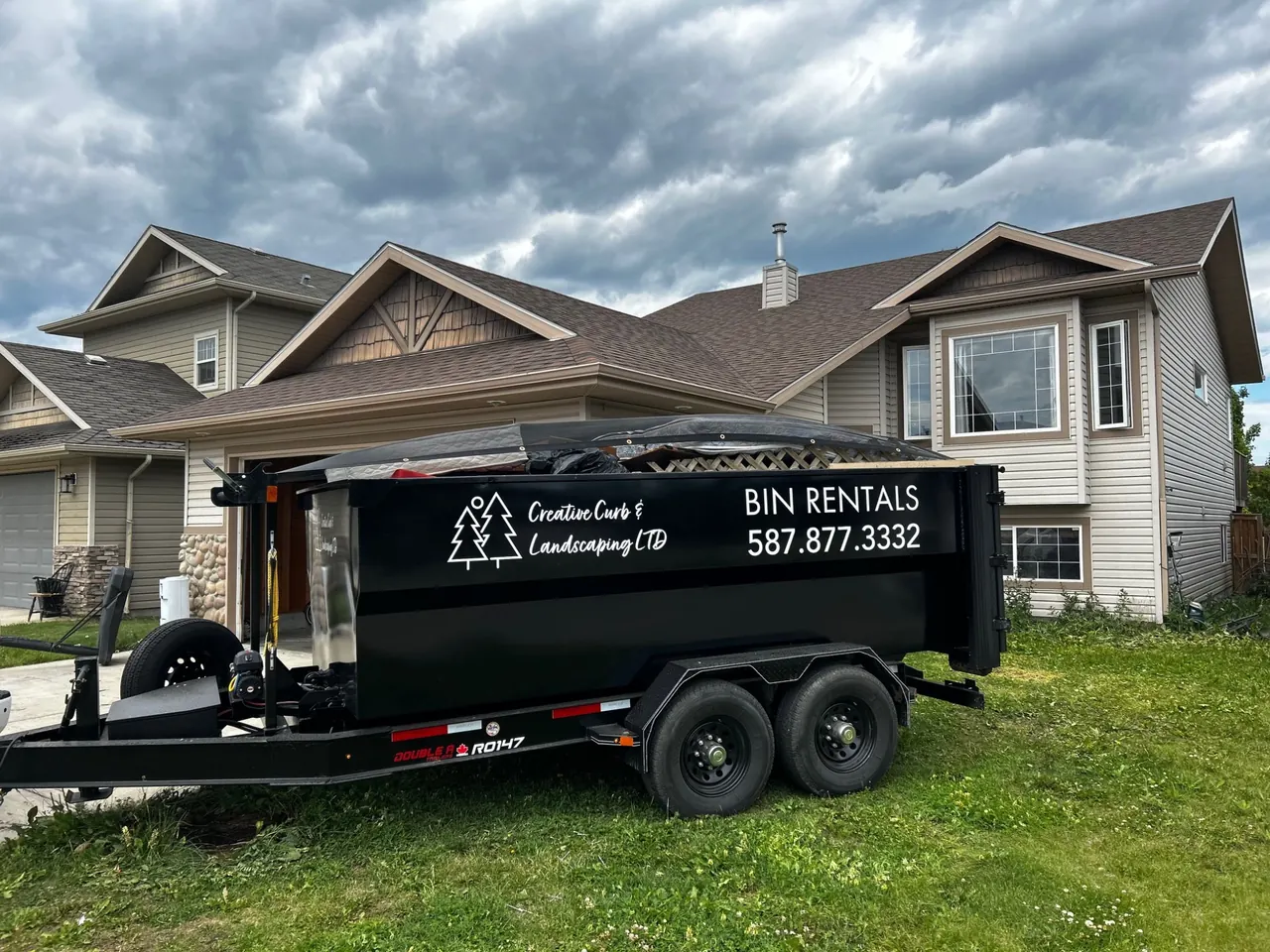 12-yard roll-off bin placed in a residential driveway in Red Deer area